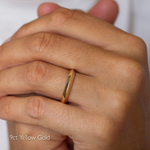 Close up of hand wearing knife edge pointed wedding ring in 9ct yellow gold