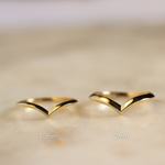 knife edge v shaped wedding ring in 1.3mm width and 2mm width on marble surface