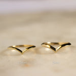 knife edge v shaped wedding ring in 1.3mm width and 2mm width on marble surface