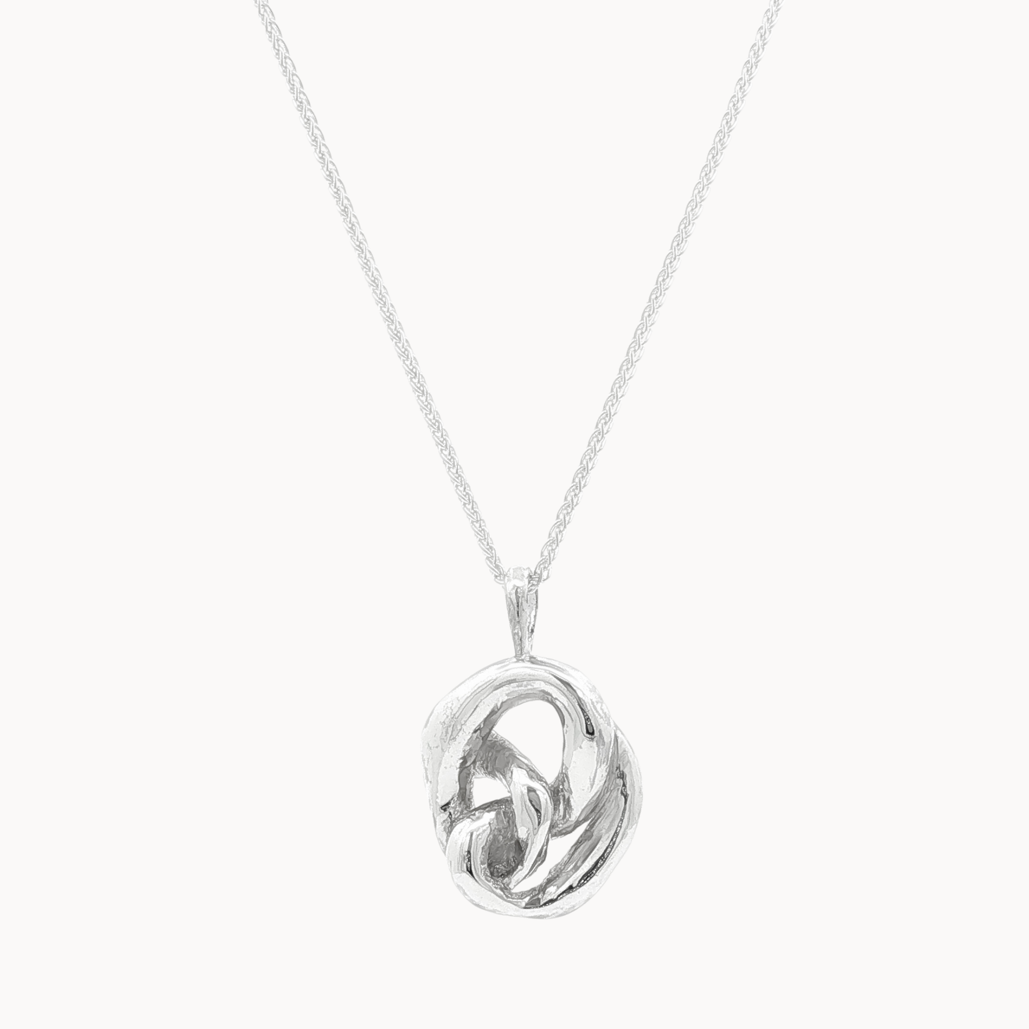 Silver necklace with a chunky knotted pendant on a white background