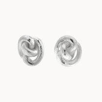 A pair of textured sterling silver knot stud earrings on a clean, off-white background.