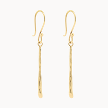 Gold dangle earrings with molten gold bar on a white background