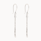 Pair of white gold hook dangle earrings with molten drop detail on a white background