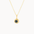 Gold necklace with a pendant featuring a dark blue sapphire on a white background