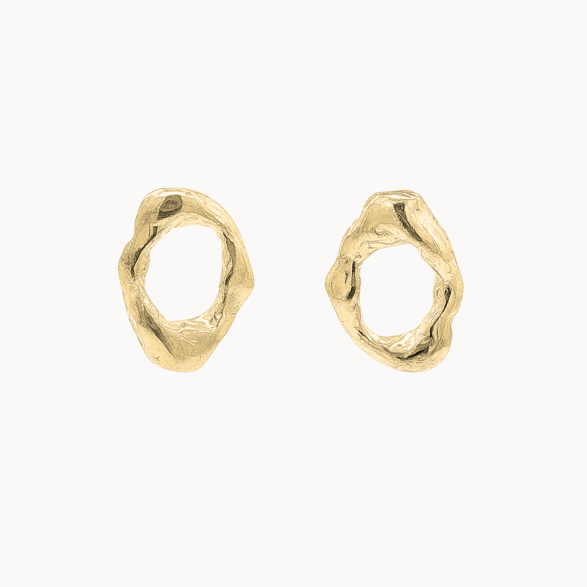 A pair of gold textured oval-shaped stud earrings on a clean off-white background.