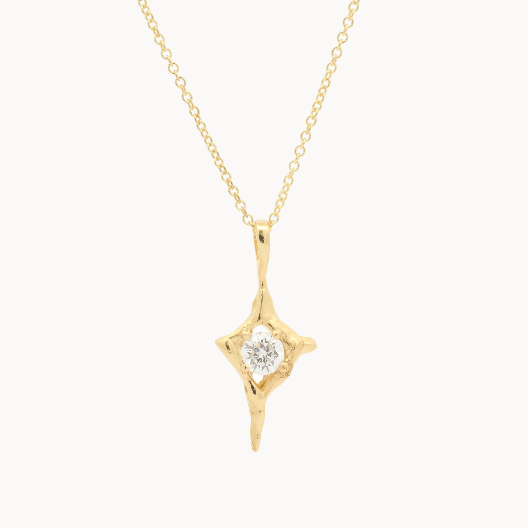 Gold necklace with a open star shaped pendant with round diamond in the middle on a white background