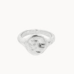 A textured sterling silver oval signet ring with a rough, organic-shaped face, shown on a plain off-white background.