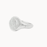 A textured sterling silver signet ring with a chunky, organic-shaped oval face, shown on a plain off-white background.