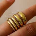 Gold d-shaped polished wedding rings on a finger with size measurements labeled 2mm 2.5mm 3mm 4mm 5mm