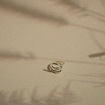s-shaped silver ring with moving plant shadows