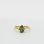 green and yellow sapphire engagement ring spinning on a turntable