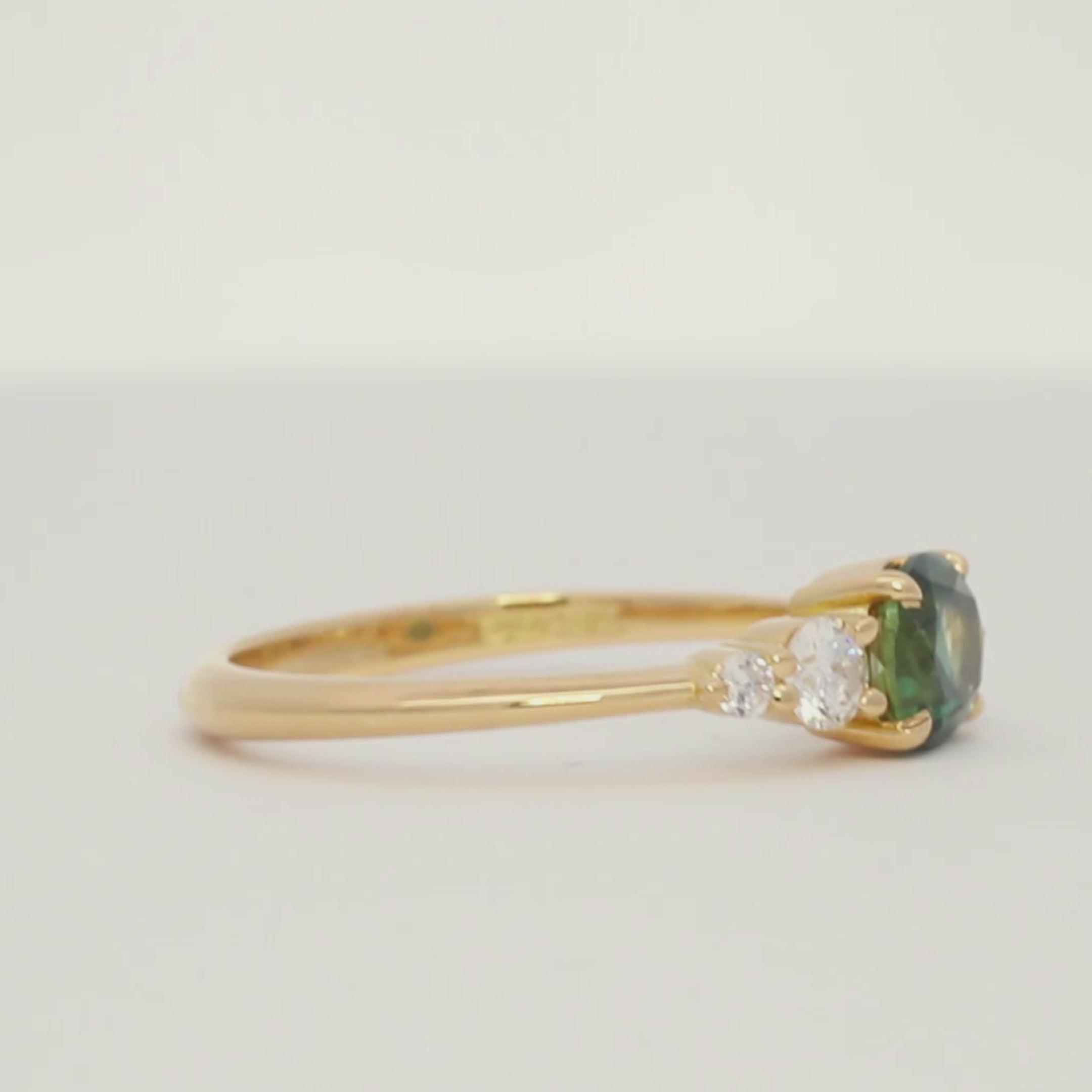 turntable video of an east-west oval sapphire engagement ring spinning