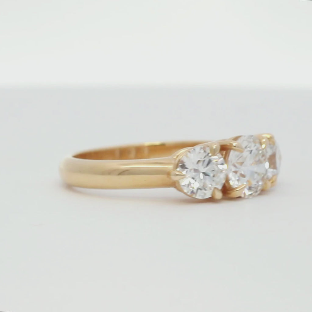 trilogy three stone diamond chunky engagement ring in yellow gold spinning on a turntable