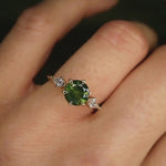 round green sapphire engagement ring with kite diamonds on moving hand