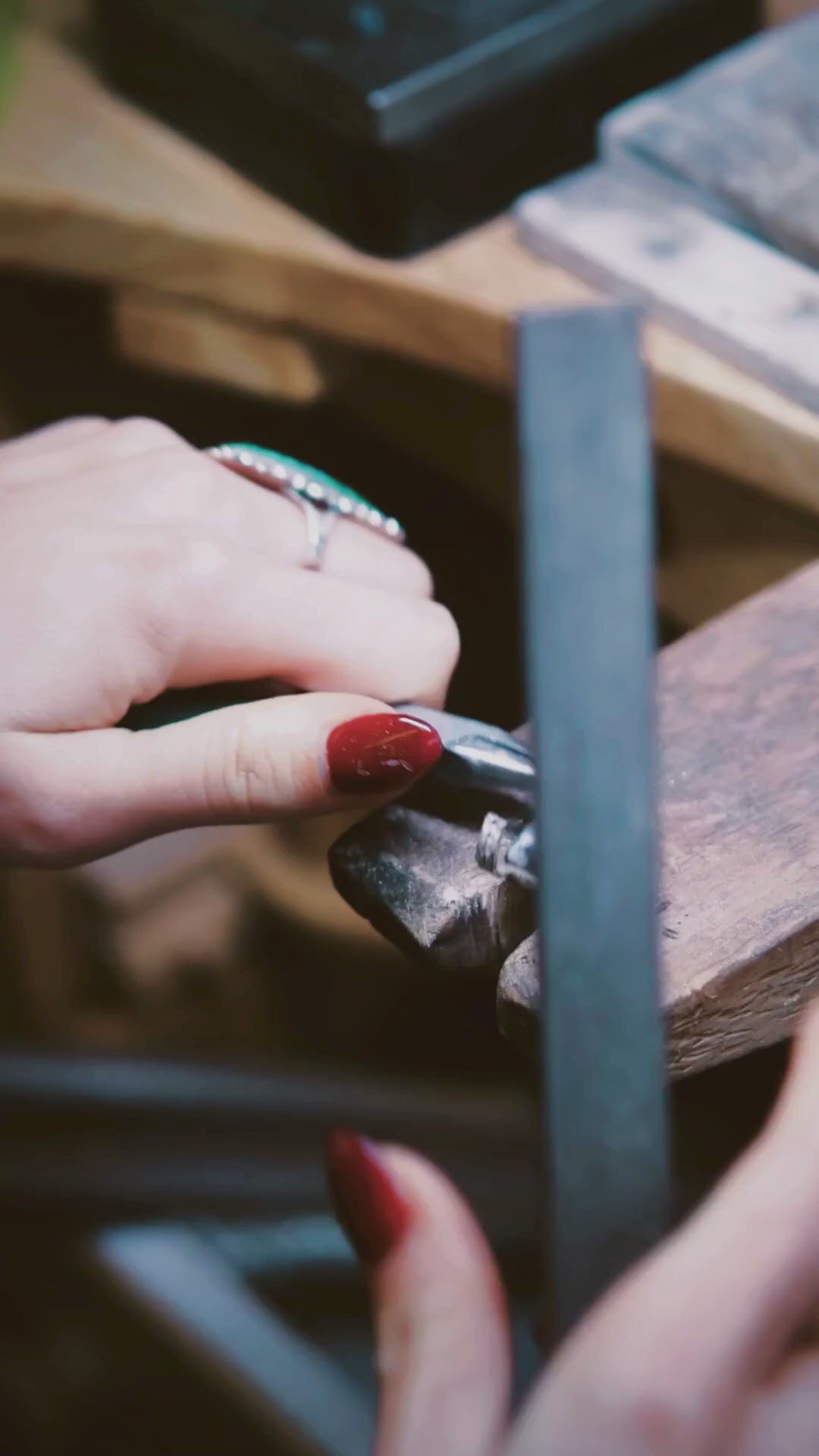 silver ring being filed, shaped and torched on a jewellery work bench