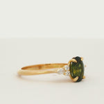 7-Stone Green Sapphire Engagement Ring with Diamond Cluster spinning on a turntable