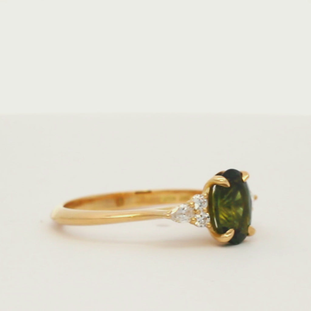 7-Stone Green Sapphire Engagement Ring with Diamond Cluster spinning on a turntable