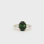 Large Bi-Colour Green Sapphire 5 Stone Engagement Ring with Tapered Diamonds spinning on turntable