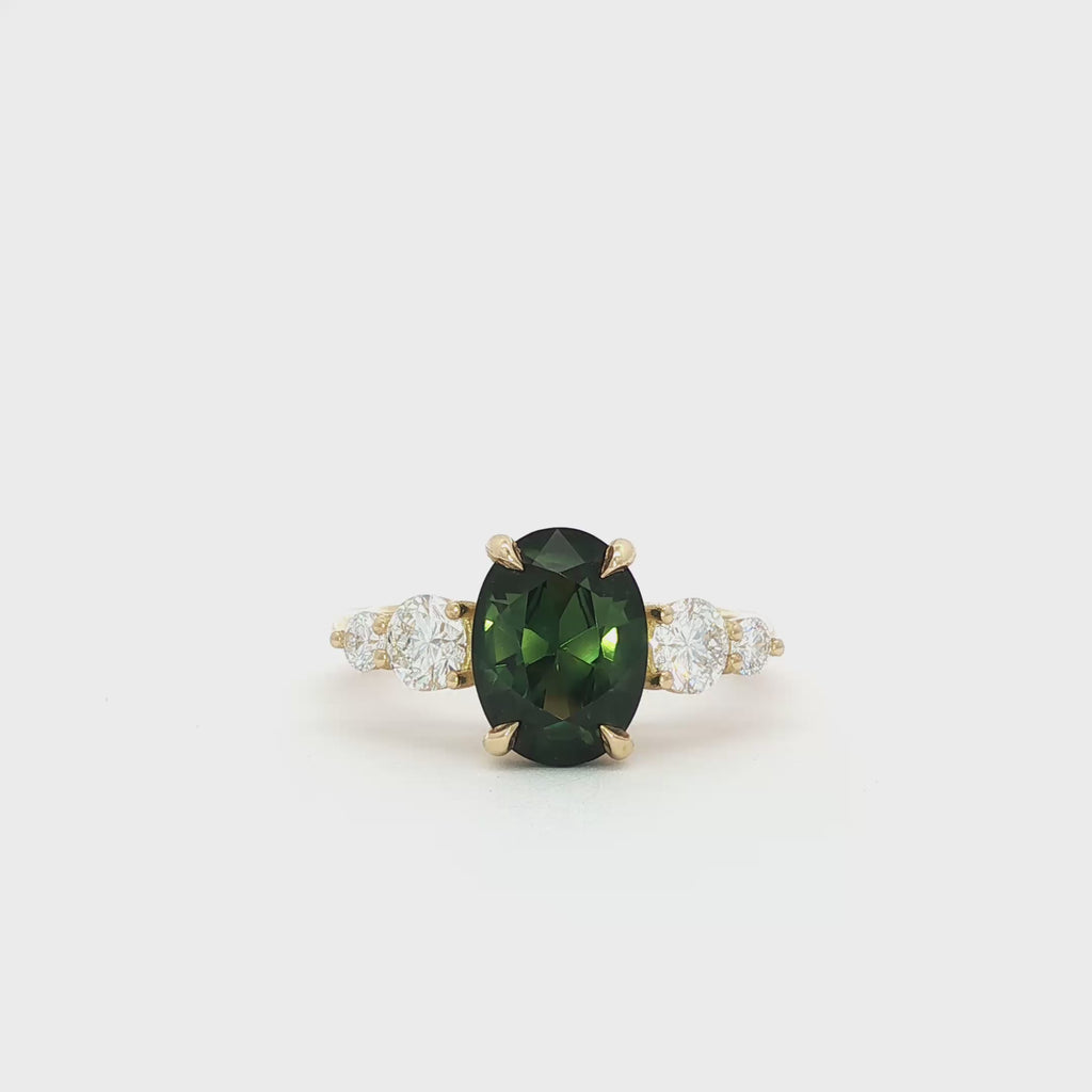 Large Bi-Colour Green Sapphire 5 Stone Engagement Ring with Tapered Diamonds spinning on turntable