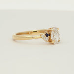 diamond engagement ring with small blue sapphires spinning on a turntable