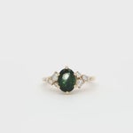 Green Sapphire Engagement Ring with Round Diamond Cluster spinning on turntable