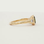 Oval Green Sapphire and Diamond Molten Organic Engagement Ring spinning on a white turntable