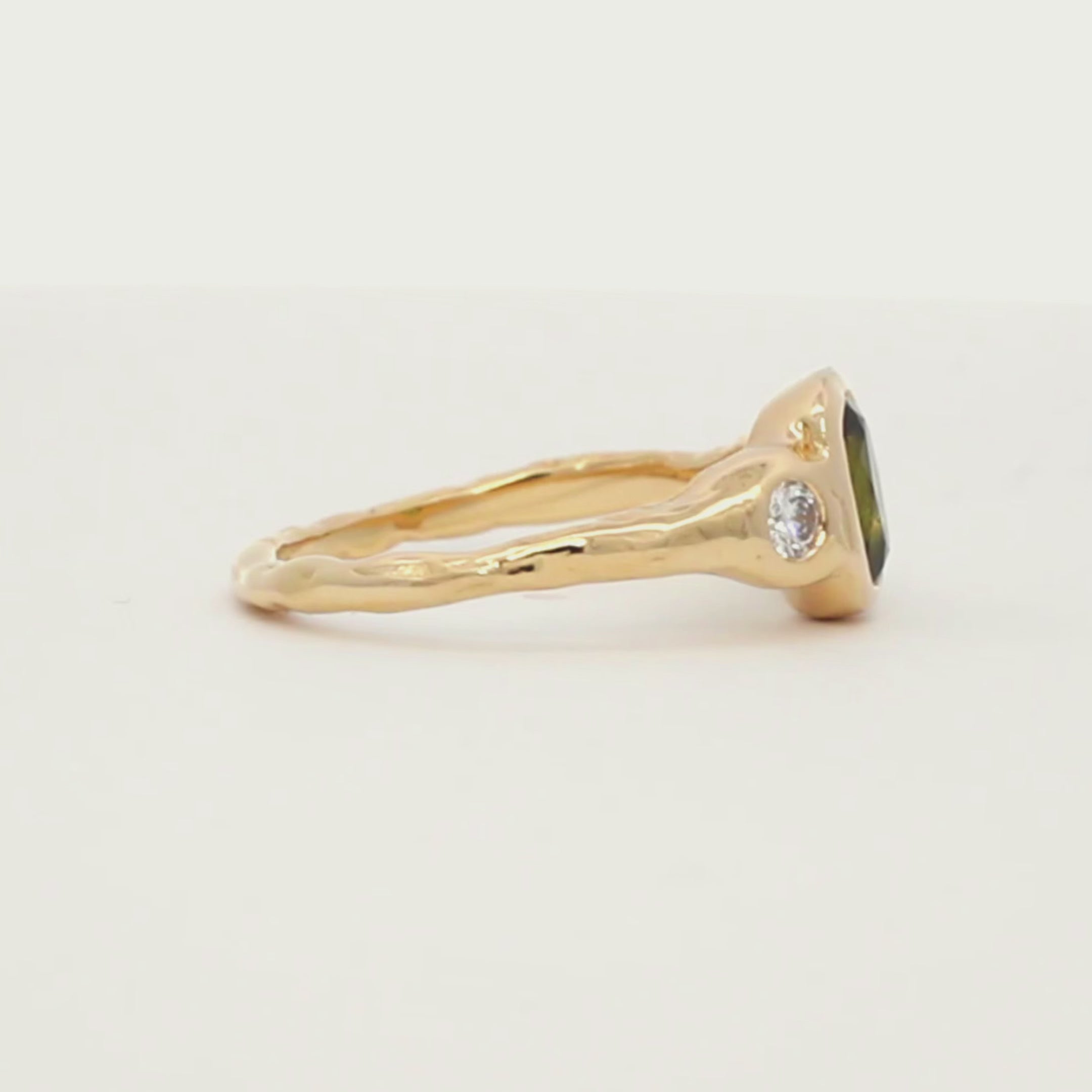 Oval Green Sapphire and Diamond Molten Organic Engagement Ring spinning on a white turntable