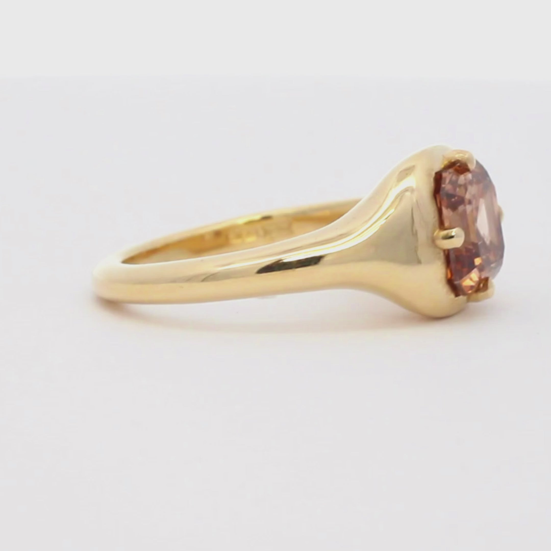 yellow gold brown diamond engagement ring spinning on a turntable