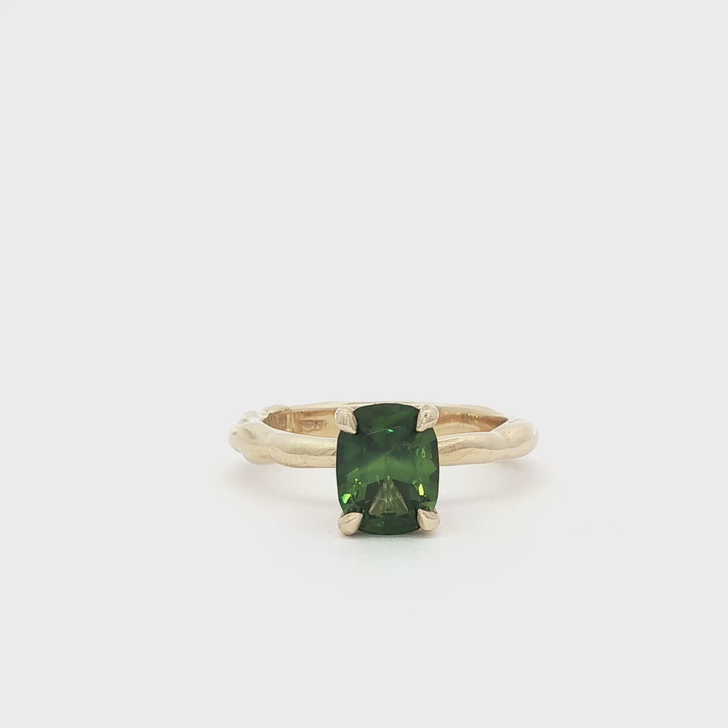 9ct Gold Green Sapphire Solitaire Engagement Ring with Organic Band spinning on turntable
