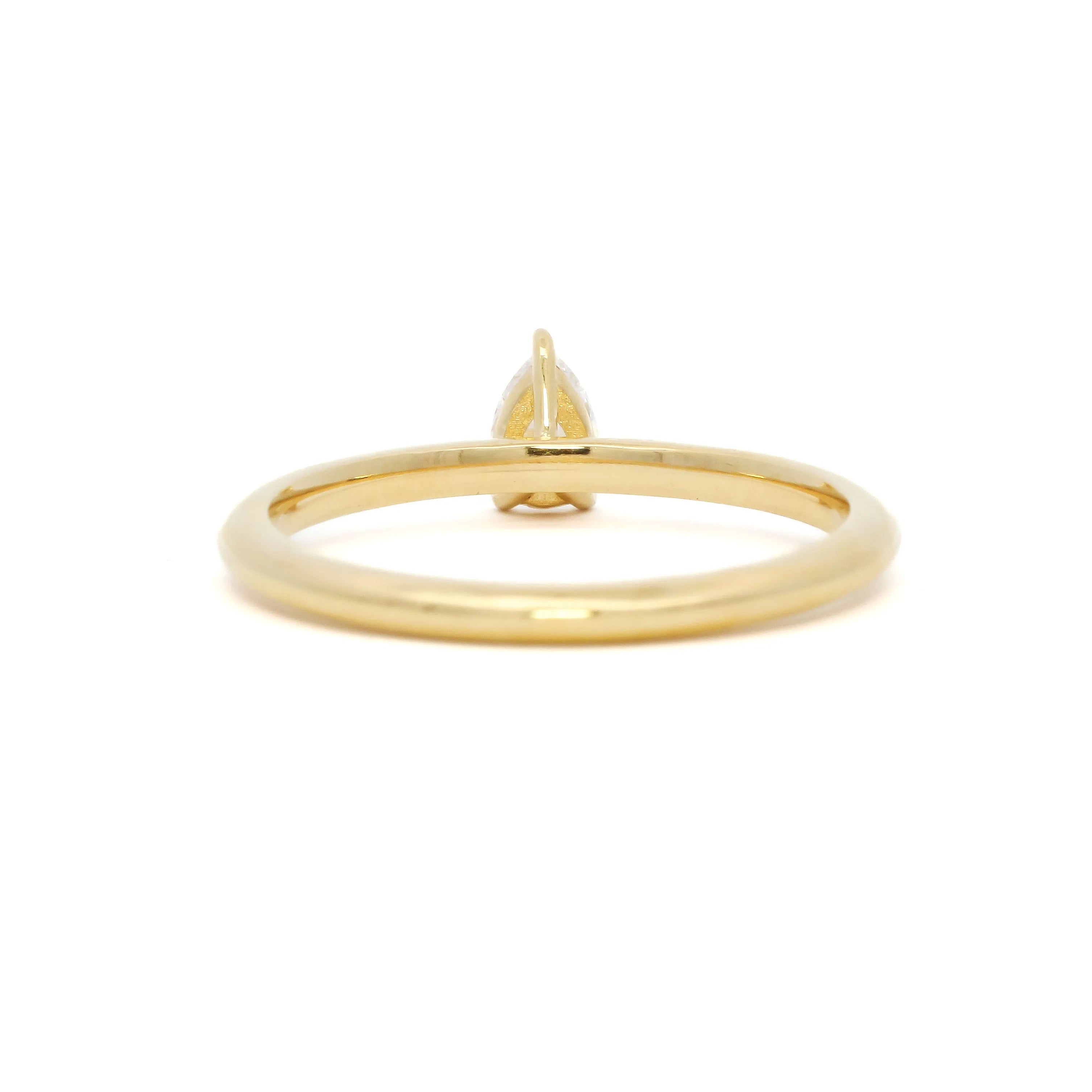 back view of a tiny pear diamond engagement ring
