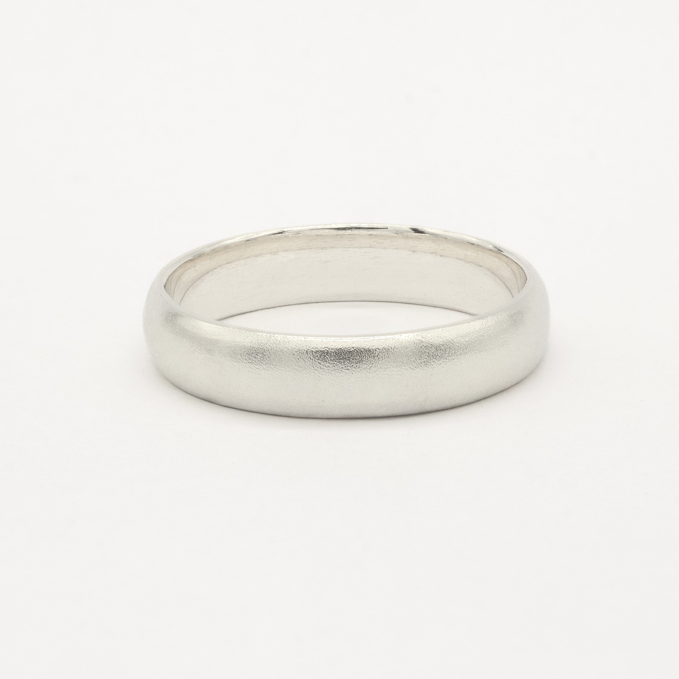 White gold satin wedding ring on a white background