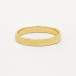 Gold satin flat wedding ring on a white background
