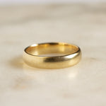 wedding ring with blurred satin finish on marble surface