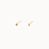 Pair of gold stud earrings on a white background