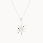 Silver-toned mini sun-shaped pendant on a chain against a white background