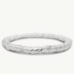 A textured silver bangle bracelet with a twisted, organic surface finish, displayed on a clean off-white background.