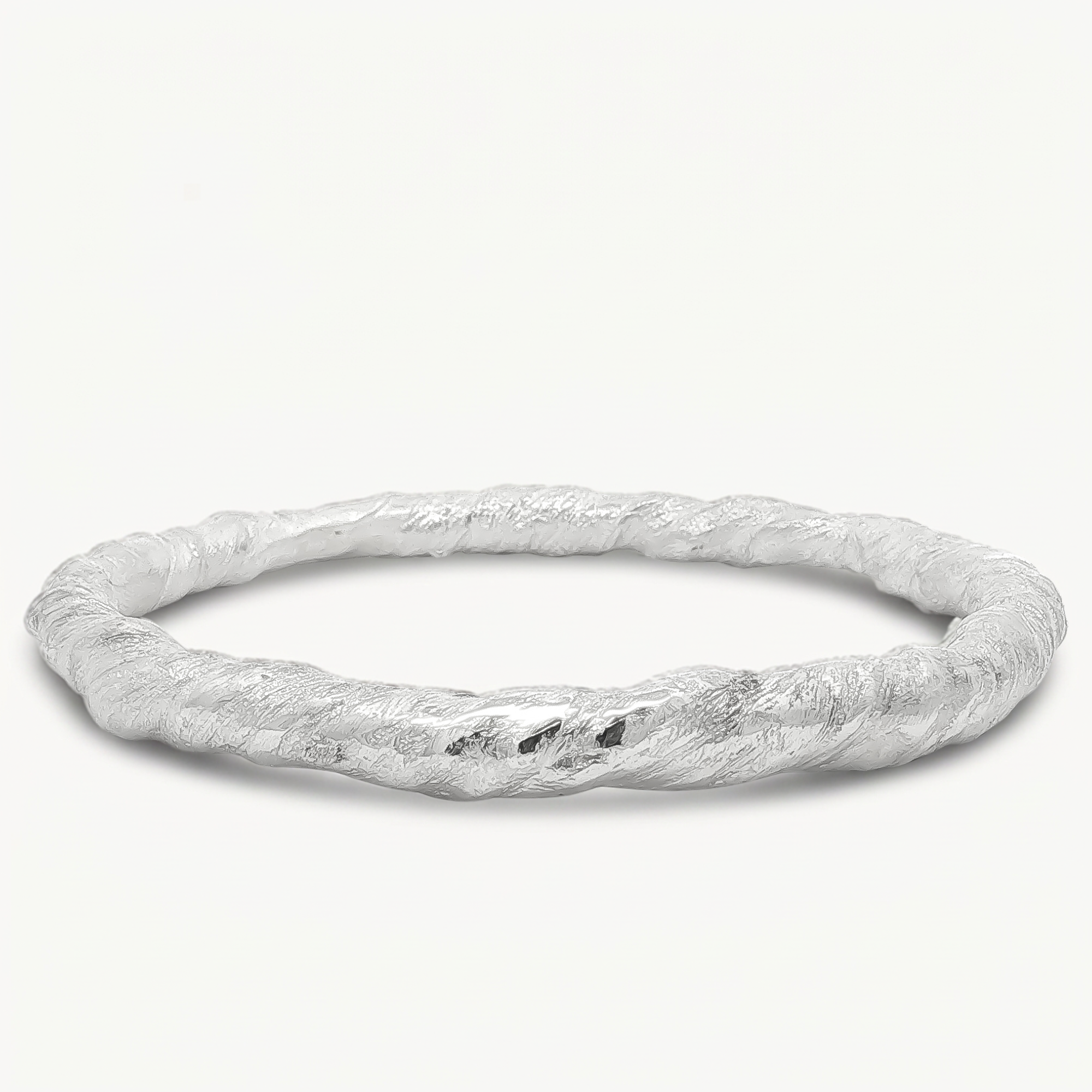A textured silver bangle bracelet with a twisted, organic surface finish, displayed on a clean off-white background.