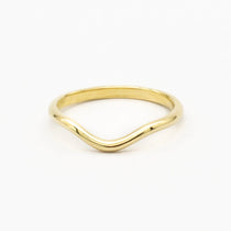 gold soft curved wedding ring with polished finish on white backhground