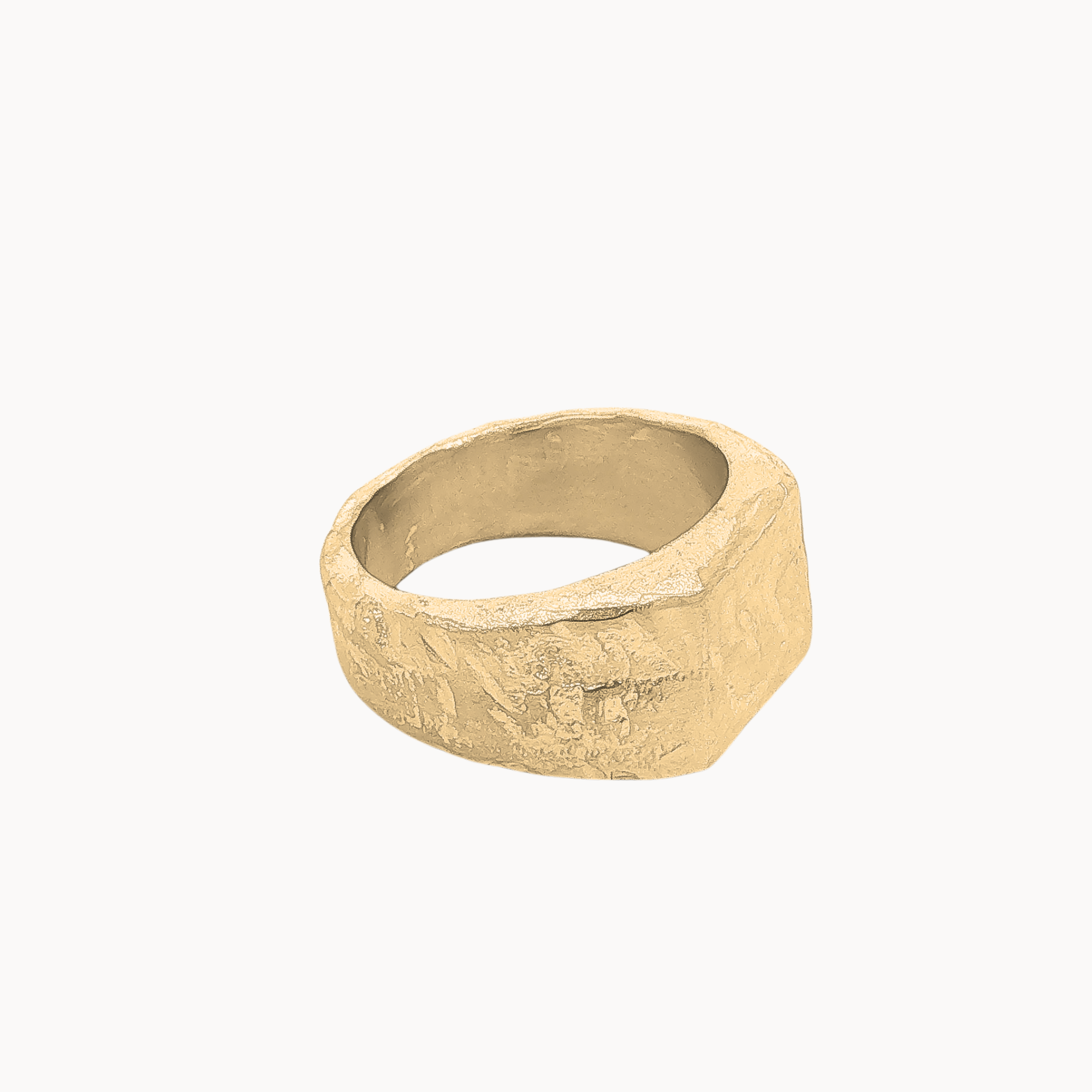 A textured, chunky signet-style ring in a warm gold finish, photographed on a clean, solid off-white background.