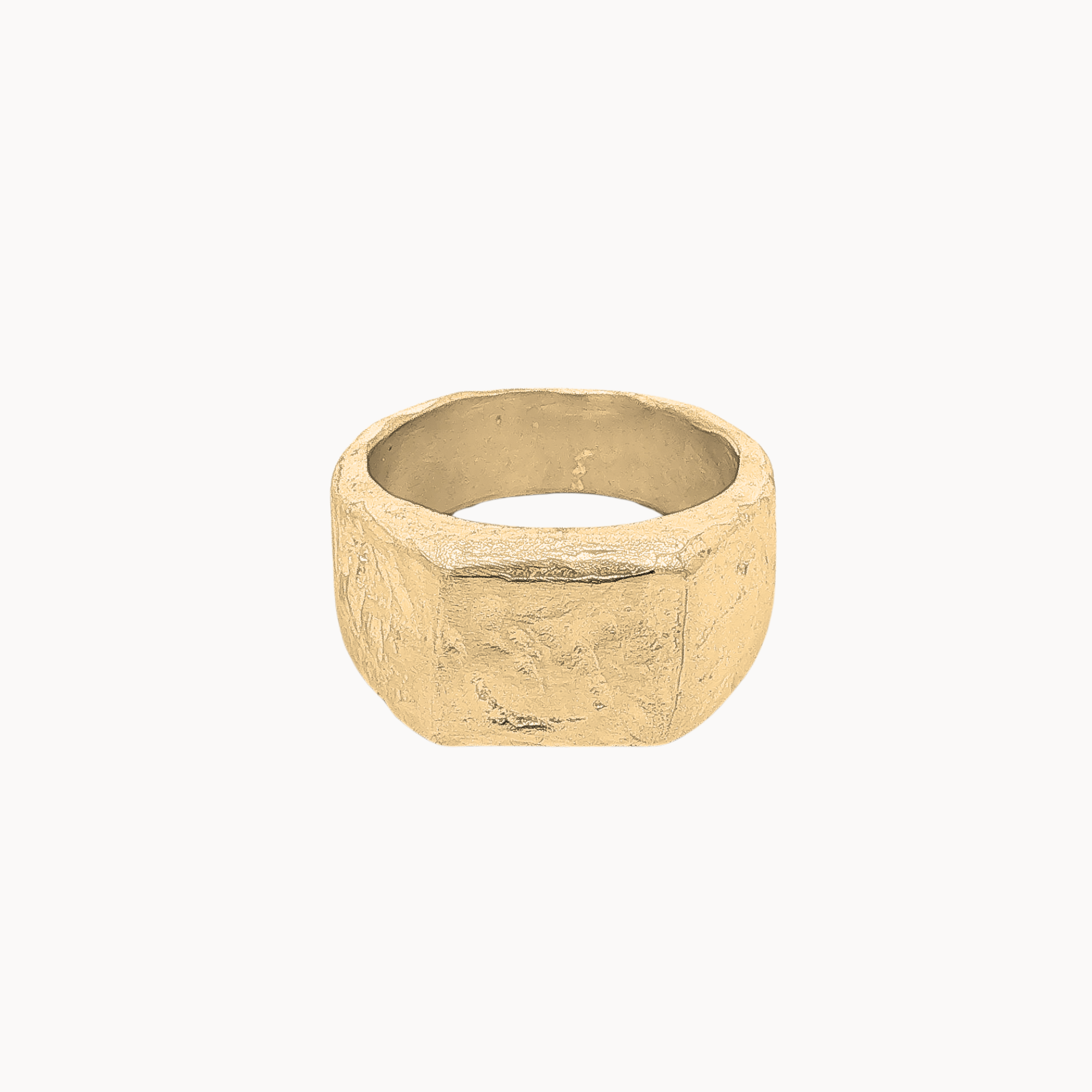 A chunky, textured gold ring with a geometric, faceted design, shown against a plain off-white background.