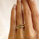 Gold star and diamond wedding rings on a hand with size labels '2mm' and '3mm' on a beige background