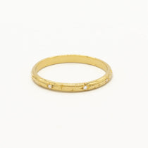 cut out of yellow gold wedding ring with star engraving and small round diamonds and shadow