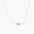 white gold four point star necklace on a fine chain against a white background