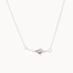 white gold four point star necklace on a fine chain against a white background