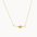 Gold necklace with a small four-pointed star pendant on a white background