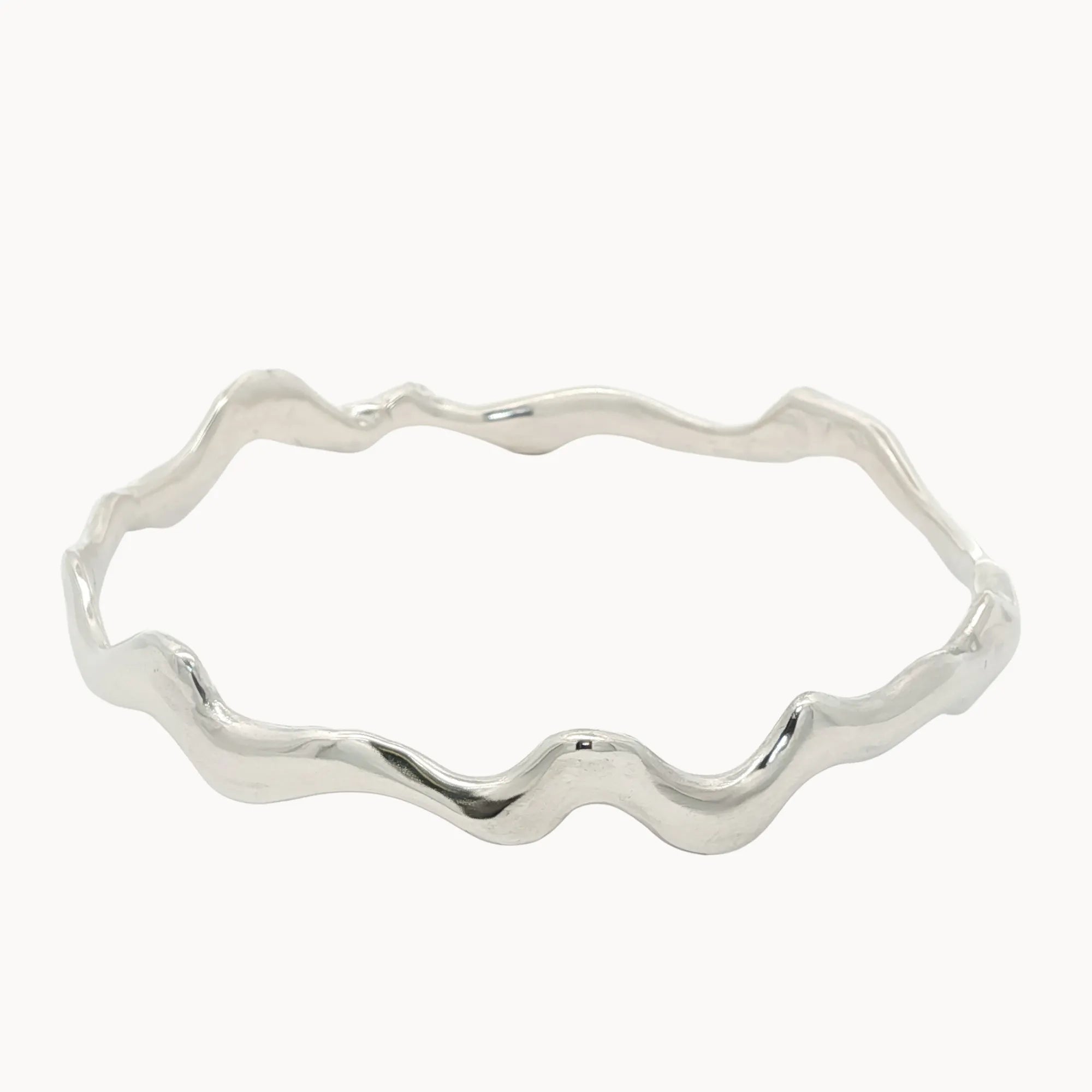 Silver bangle with wavy design on a white background