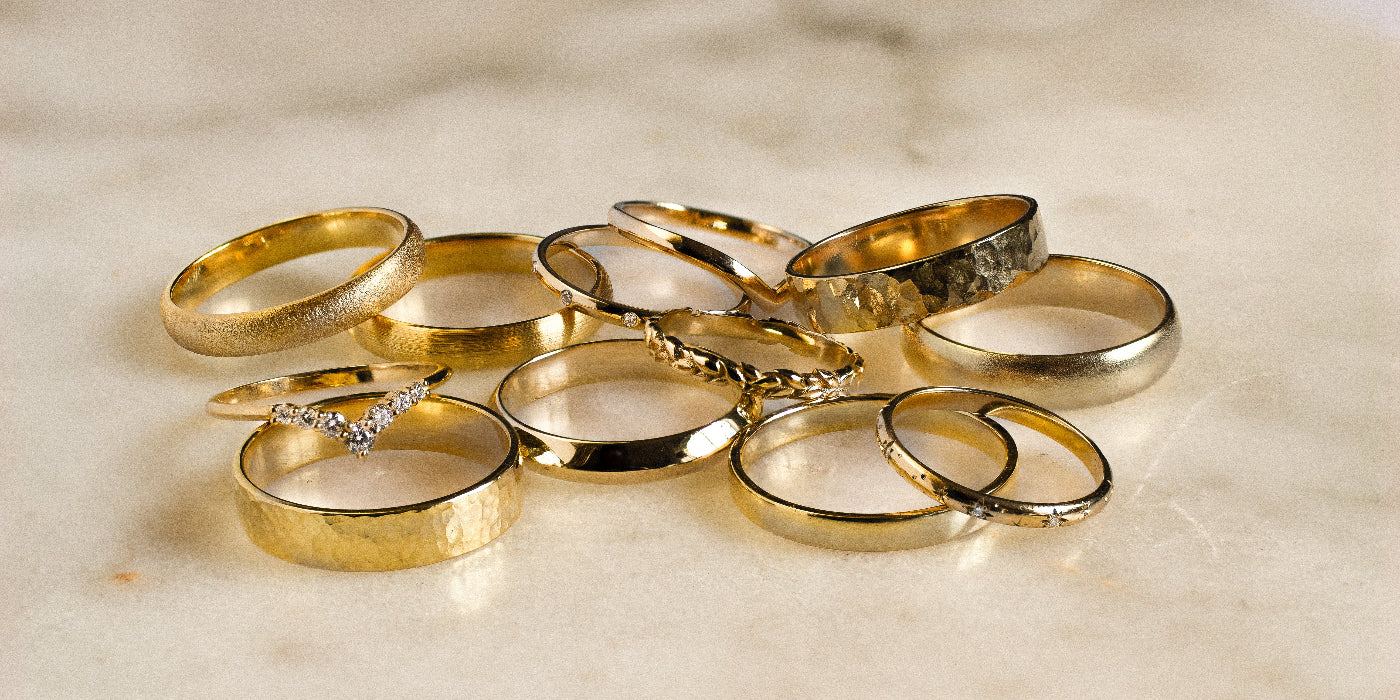 Collection of gold rings on a marble surface