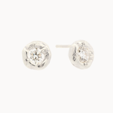 white gold round diamond stud earrings with molten texture on a white background