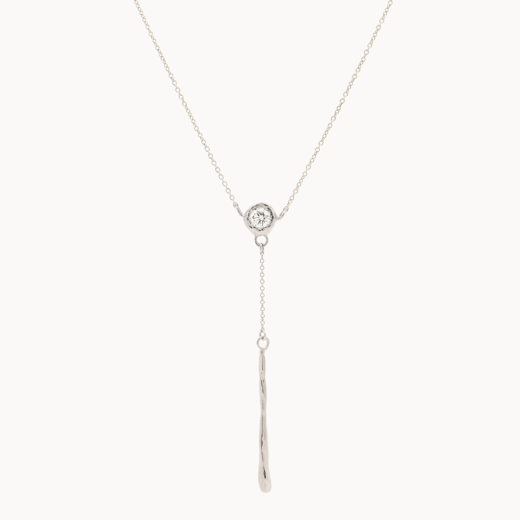 white gold y-shaped lariat necklace with a small round diamond pendant and molten bar detail on a white background