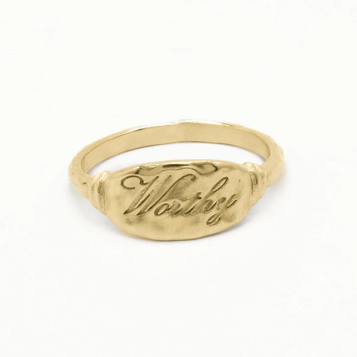 solid gold word ring engraved with 'Worthy' in script font on a white background